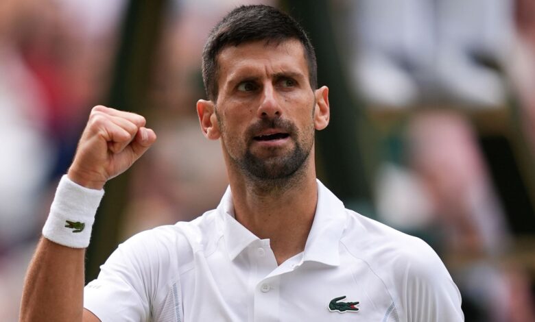 Novak Djokovic shakes hands with an injured Lorenzo Musetti at the net.